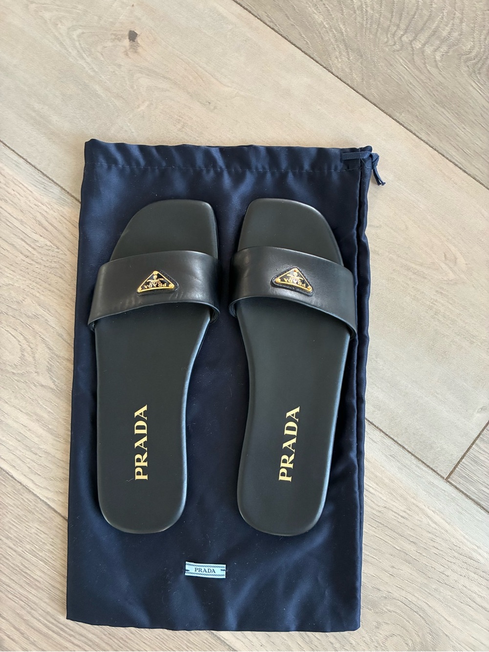 Prada Black Leather Logo Slide Sandals with Gold Emblem